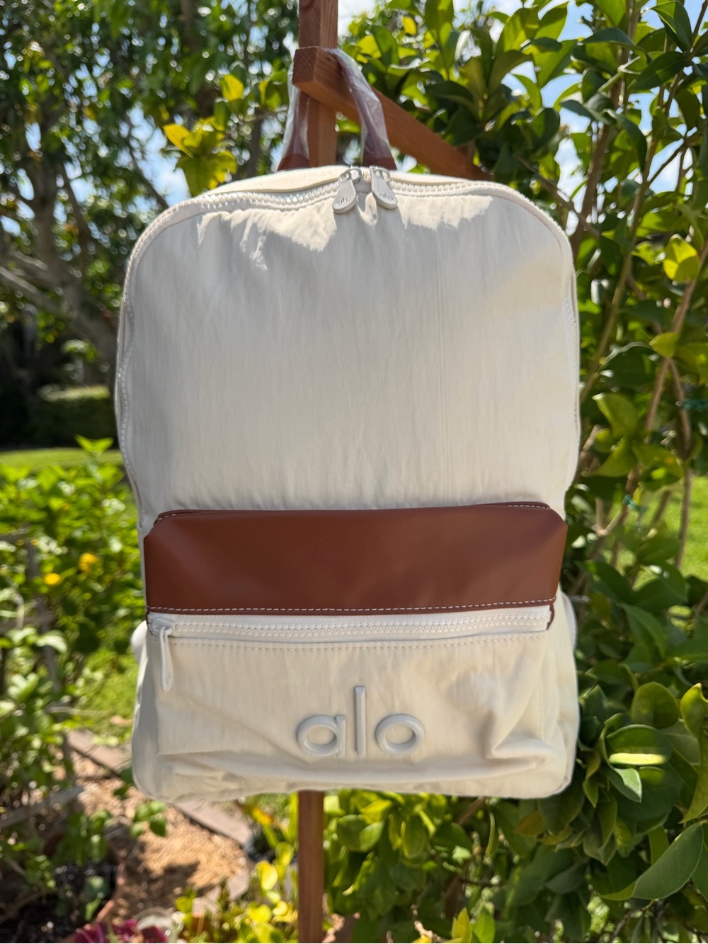 ALO Yoga Cream Backpack with Brown Front Accent
